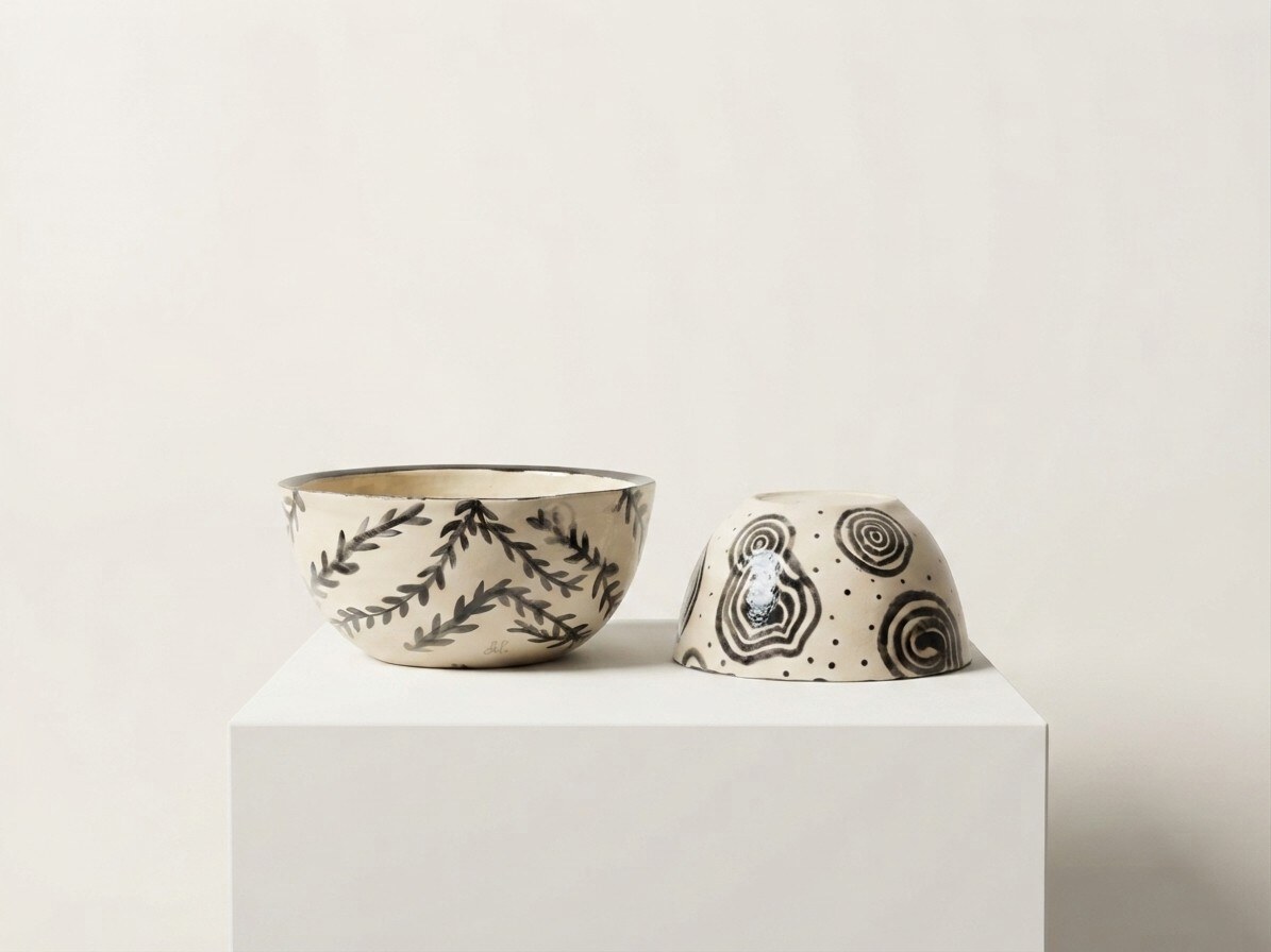 Botanical Bowls — a pair of hand-painted cream bowls with black leaf sprigs and concentric spirals