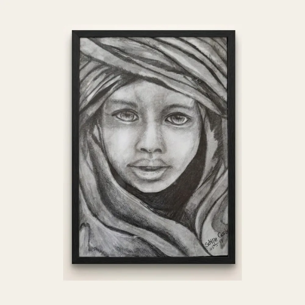 Headscarf — a charcoal portrait of a child wrapped in a draped headscarf, in a slim black frame.