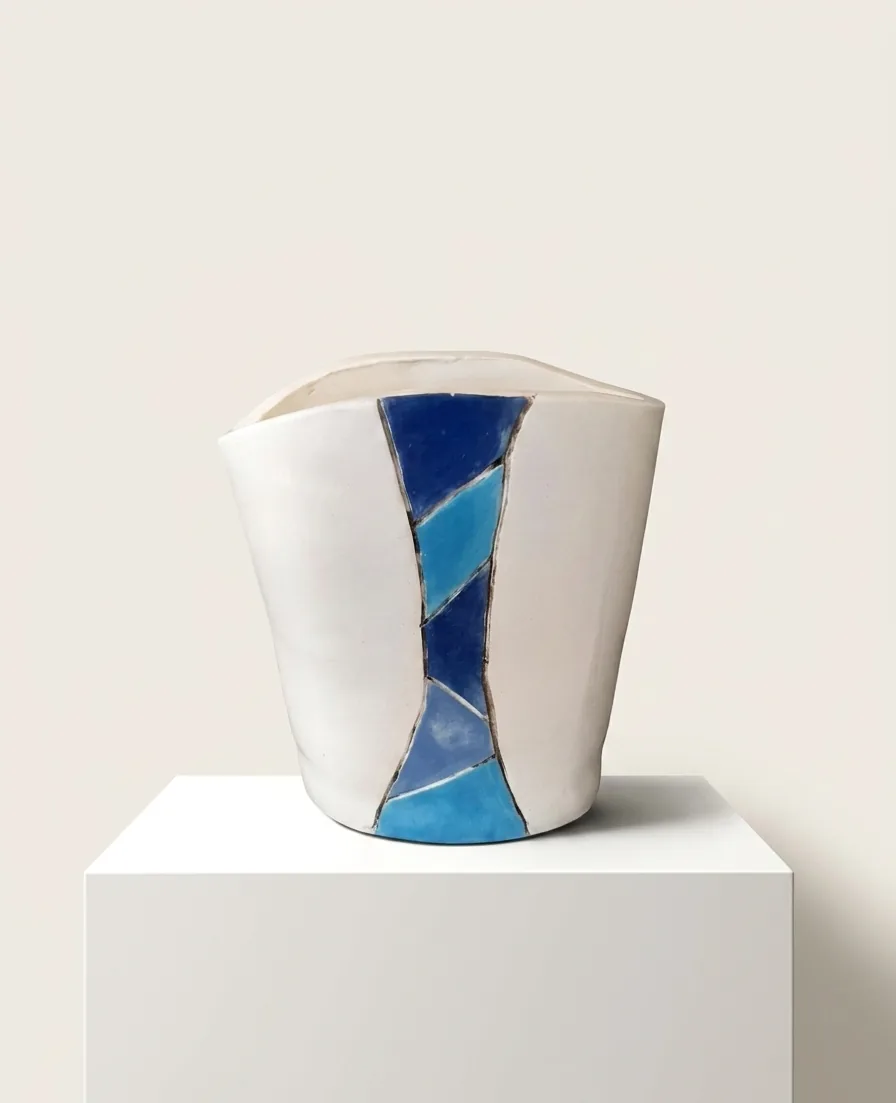Cobalt Facet Vessel — a soft-edged white vessel with a panel of cobalt and turquoise facets running down one side.