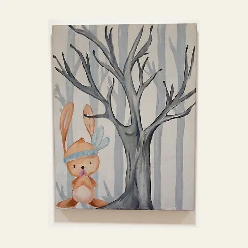 Woodland Hare — a small hare in a blue feather headband beside a bare tree in a pale winter wood.